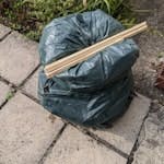 3 bags of garden waste 3 bags of garden waste (rose and hedge cuttings), and the remnants of a cheap wood frame. outside on garden path SW19