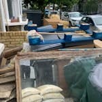 Garden and builders waste Approx. 40 rubbles sacks, 1bbq,
3 sheets of ply with mirror attached
3 fence panels
3 metal kitchen drawers 
Broken palette
2 sleepers
Misc wood cut offs
Chimney pot cover
Approx. 10 empty paint tins
Some loose concrete rubble - see photo N16