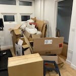 Cardboard and furniture Large pile of cardboard and packing material and a small broken set of drawers. NW3