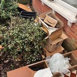 broken tv stand, cardboard box mix of cardboard boxes, tv stand and other household waste (pallet) - needs collecting asap. please collect everything at the front of the house. SW14