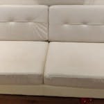 Two seater mock leather sofa White sofa, getting rid due to the room getting turned into a play room. Some light scratches to one cushion, photo attached. It comes in one piece, cushions removable WS7
