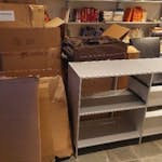 cardboard, chair and sideboard mostly cardboard, a chair with a footrest (good condition), a sideboard with one missing panel but usable, and a suitcase with a broken handle. Some boxes contain filling material. Easy access just next to the entrance. EC1Y