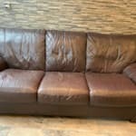 Three seater leather sofa Three seater leather sofa with wooden feet.  Large sofa.  Has a tear in it but can be fixed and used again.  It has been a great sofa but we need the space now. HX5