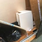 Cardboard boxes, bags of tiles 2 or 3 empty cardboard boxes, a couple of blinds and 2 light bags of broken wall tiles (in heavy duty bags) and a small under sink vanity unit (chipboard? only - no basin. W3