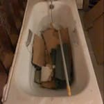 bath, water tank, bags, timber 25-30 rubble bags with plasterboard and timber laths, water tank size of bath, bath with taps and shower head, timber studwork, skirting and architrave, glass shower screen, 3 doors. N8