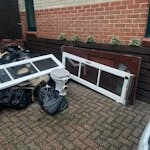 various bags, wooden doors Various black bags of rubbish, old toilet and cistern, one wooden external door. Two wood and glass patio doors, small pieces of wood, general debris E4