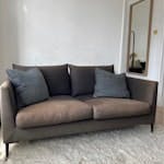 two seater sofa two seater approx 150cm black linen sofa on steel legs (removable). In good condition except fabric which has faded from sunlight. SW11